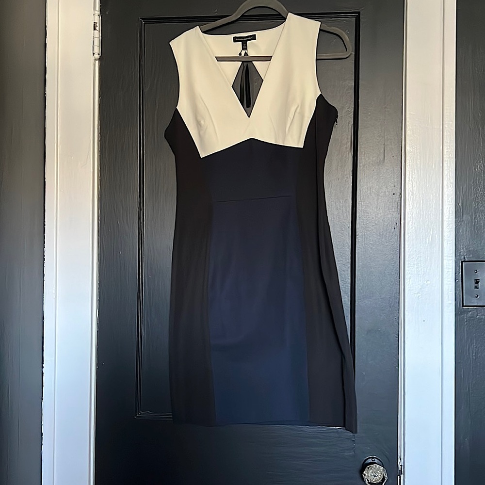 black dress with a cream, top,navy insert in the front has a very detailed back